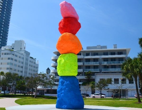 A stack of painted rocks in rainbow order