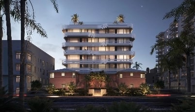 Brightly lit mid-rise condo at night