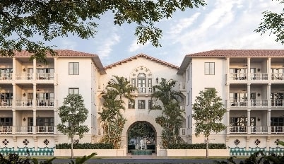 An elegant Mediterranean-style building overlooking a pool