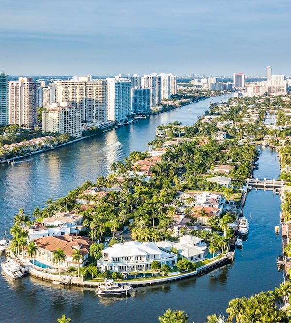 Aerial view of condo buildings next to the water