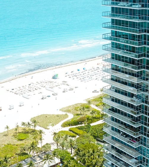 Aerial view of building next to ocean